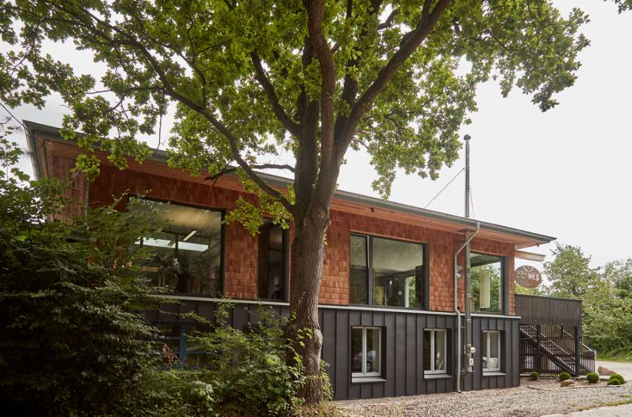 German timber company clads its main office building in wood and steel profiles